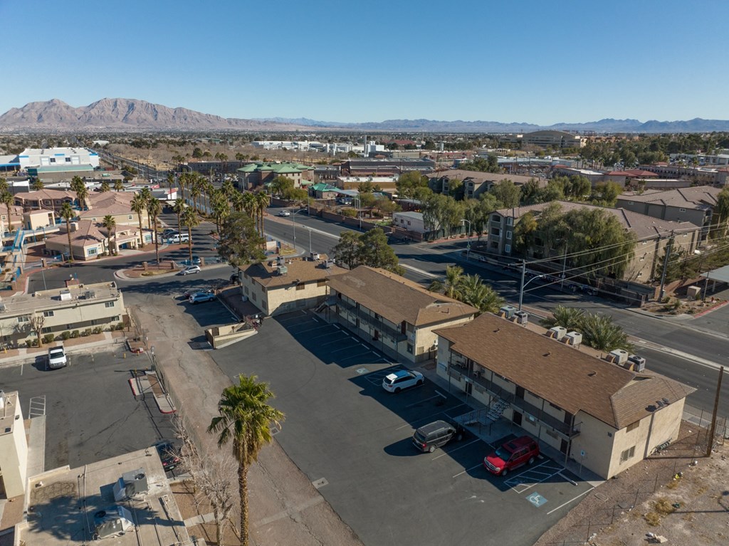 an aerial view of a city with buildings and palm trees