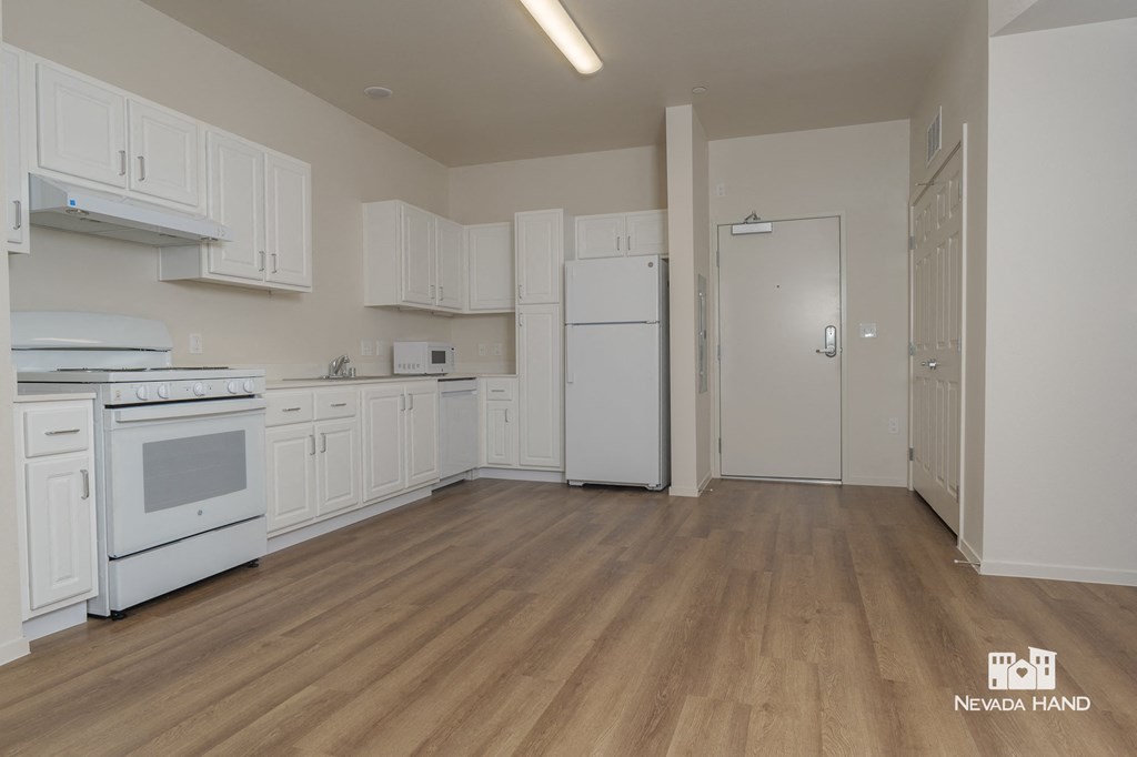 a kitchen with white cabinets and white appliances and a white refrigerator