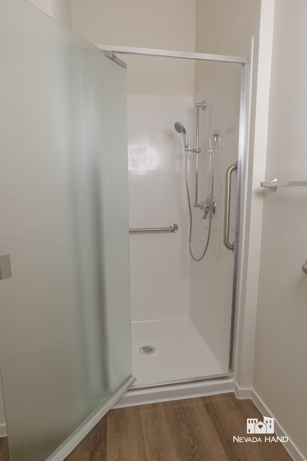 a shower in a small bathroom with a glass door