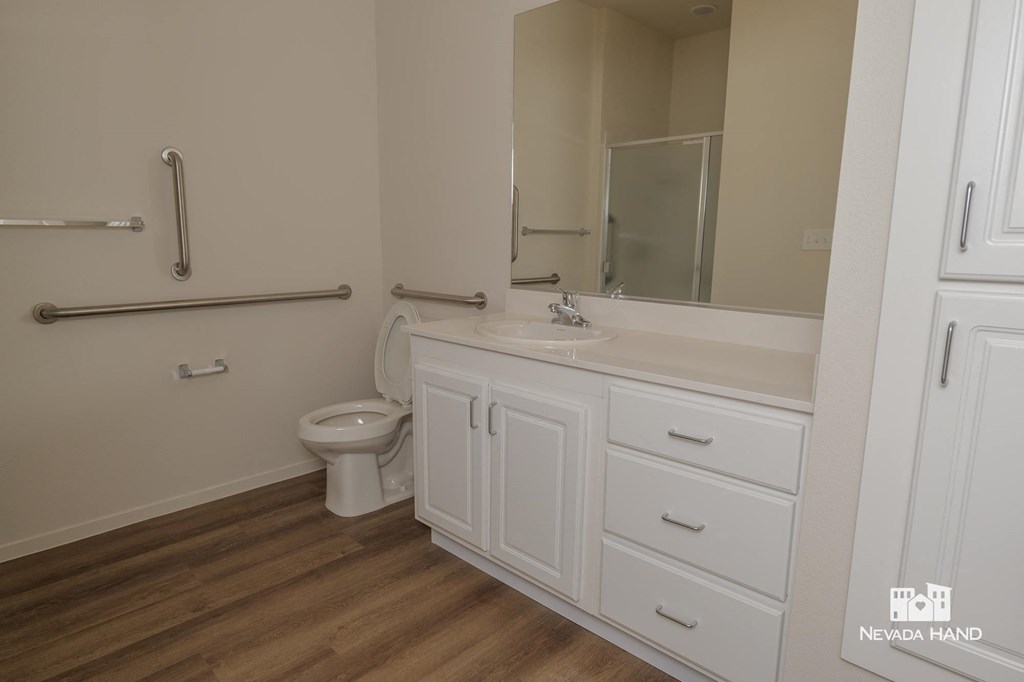 a bathroom with a sink toilet and a mirror