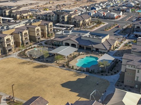 A bird's eye view of a residential area with houses and a swimming pool.