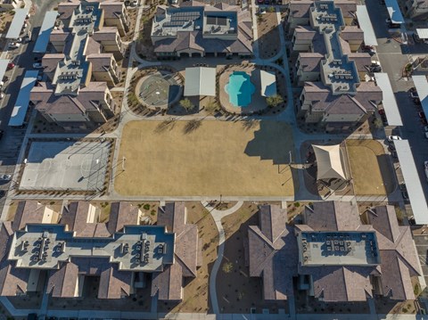 A bird's eye view of a residential area with houses and a playground.