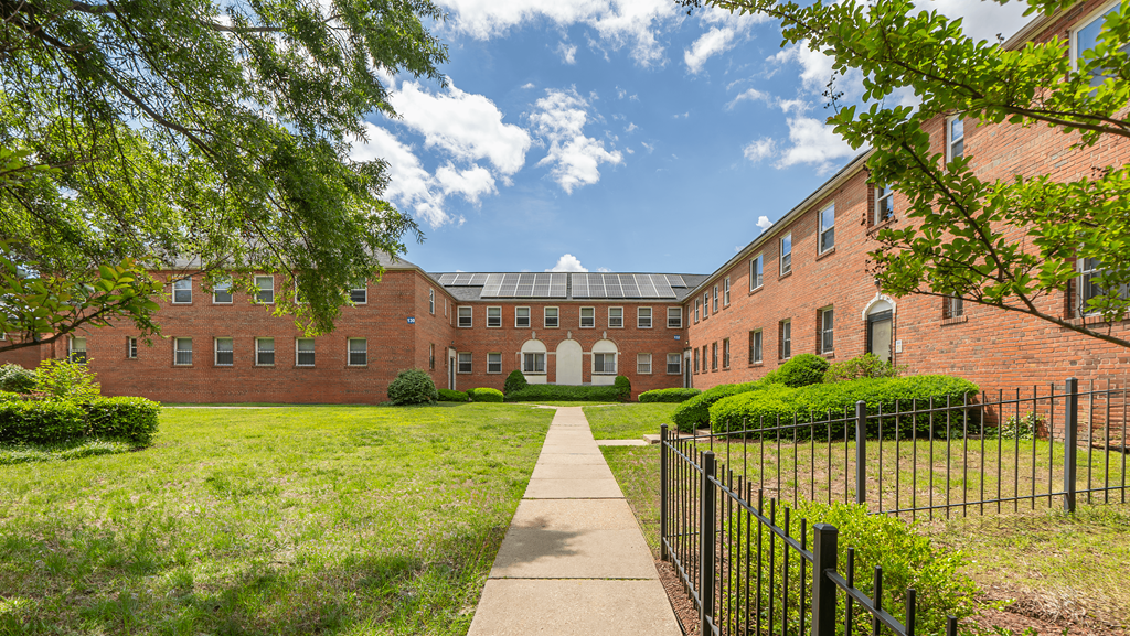 A long brick building with a walkway in front at Eagles Crossing Apartments, Washington DC, 20032