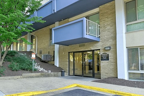 a building with a glass door and a balcony at Waterford Tower Silver Spring, LLC, Silver Spring