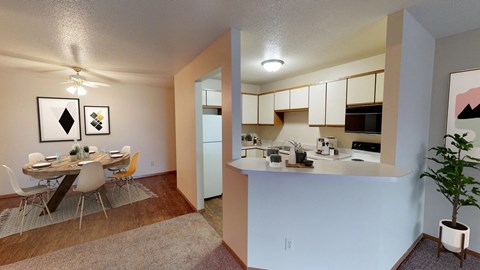 A kitchen area with a dining table and chairs.