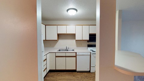 A small kitchen with white appliances and cabinets.