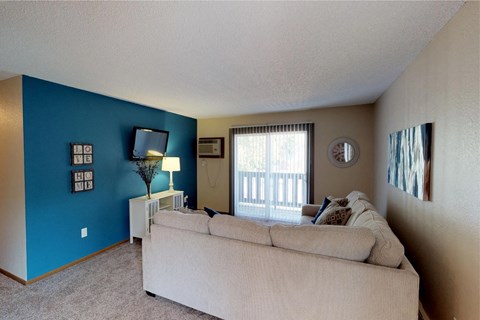A living room with a couch and a lamp.