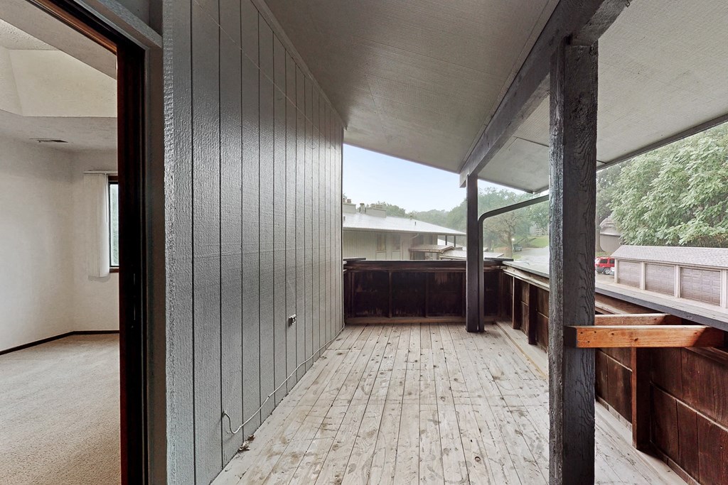 a view of the deck from the living room of a house with a large window