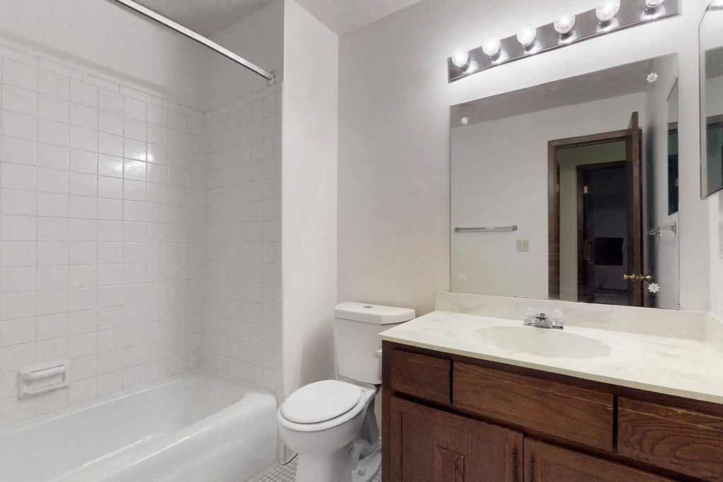a bathroom with a sink toilet and a mirror