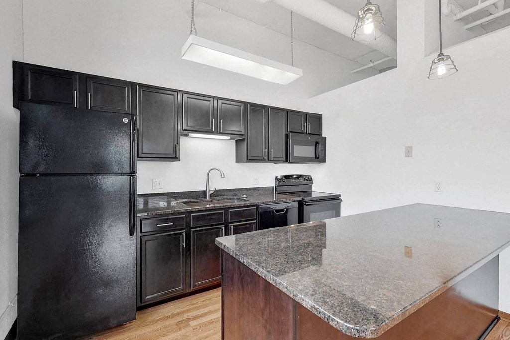 a kitchen with black appliances and granite counter tops