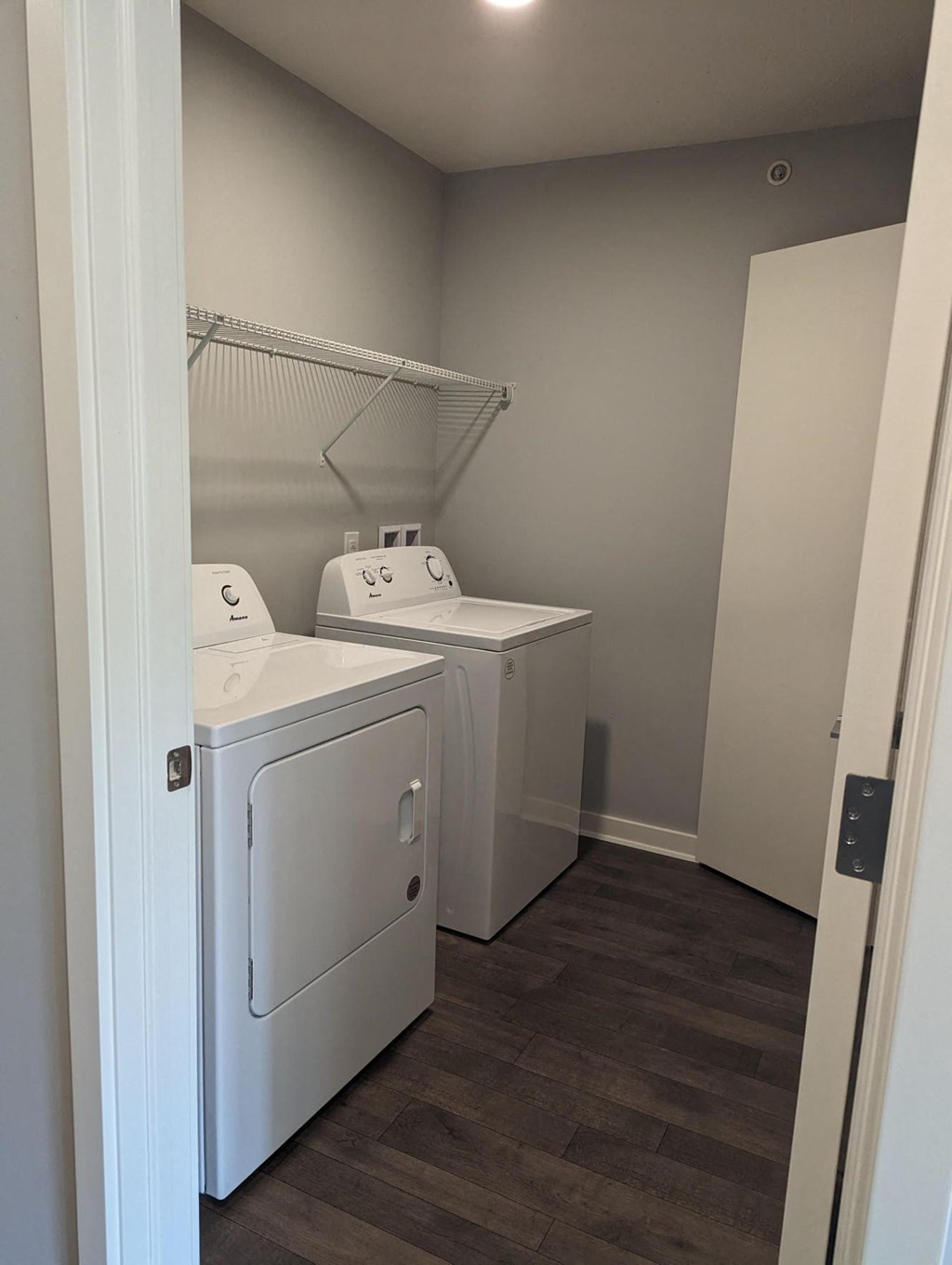 a laundry room with two washes and a dryer