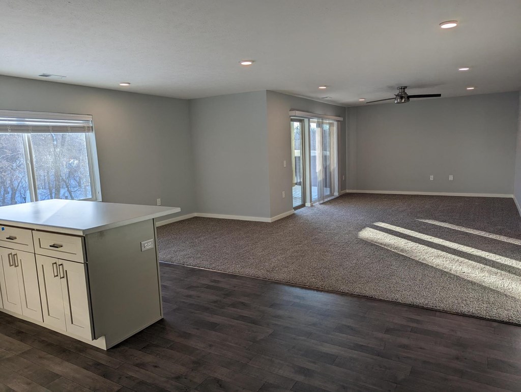 a kitchen and living room with a door to a patio