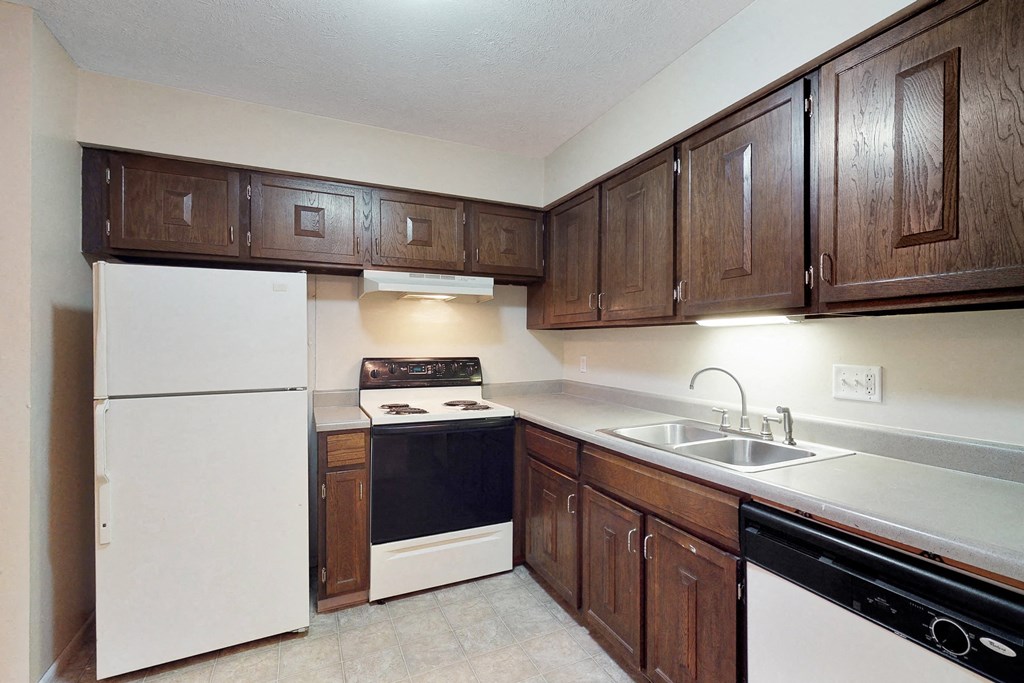 a kitchen with white appliances and dark wood cabinets