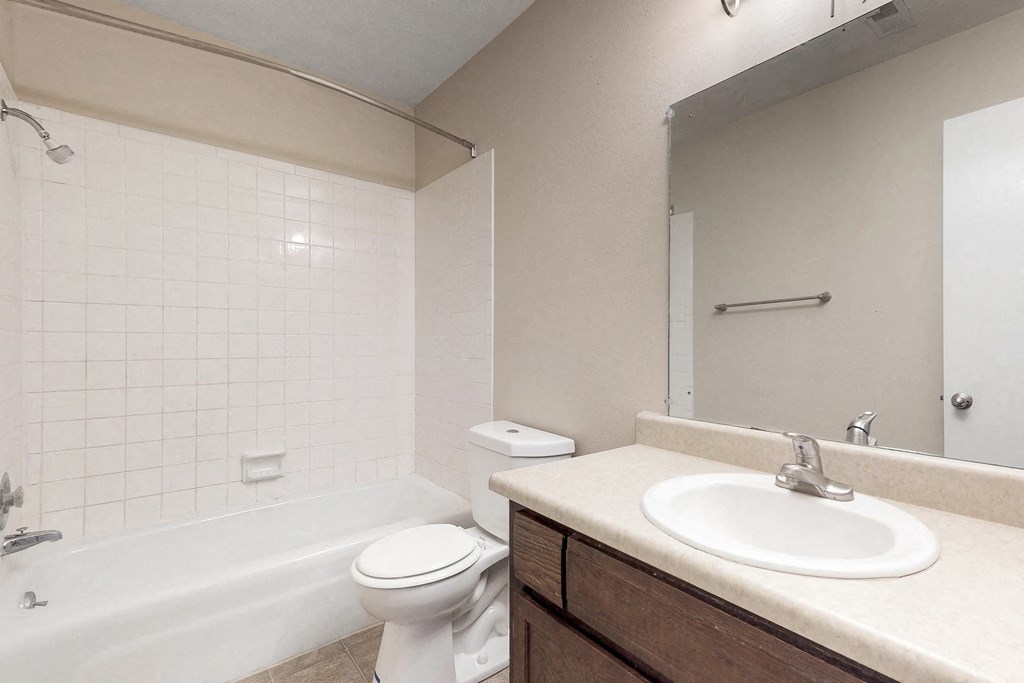 a bathroom with a sink toilet and a bath tub