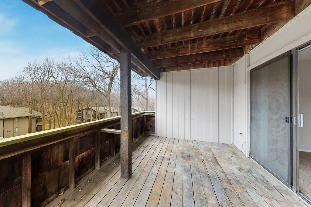 the deck has a sliding glass door to the backyard