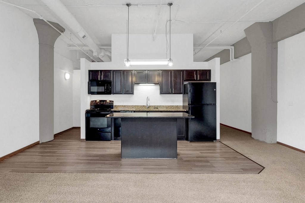 a kitchen with an island in the middle of a room