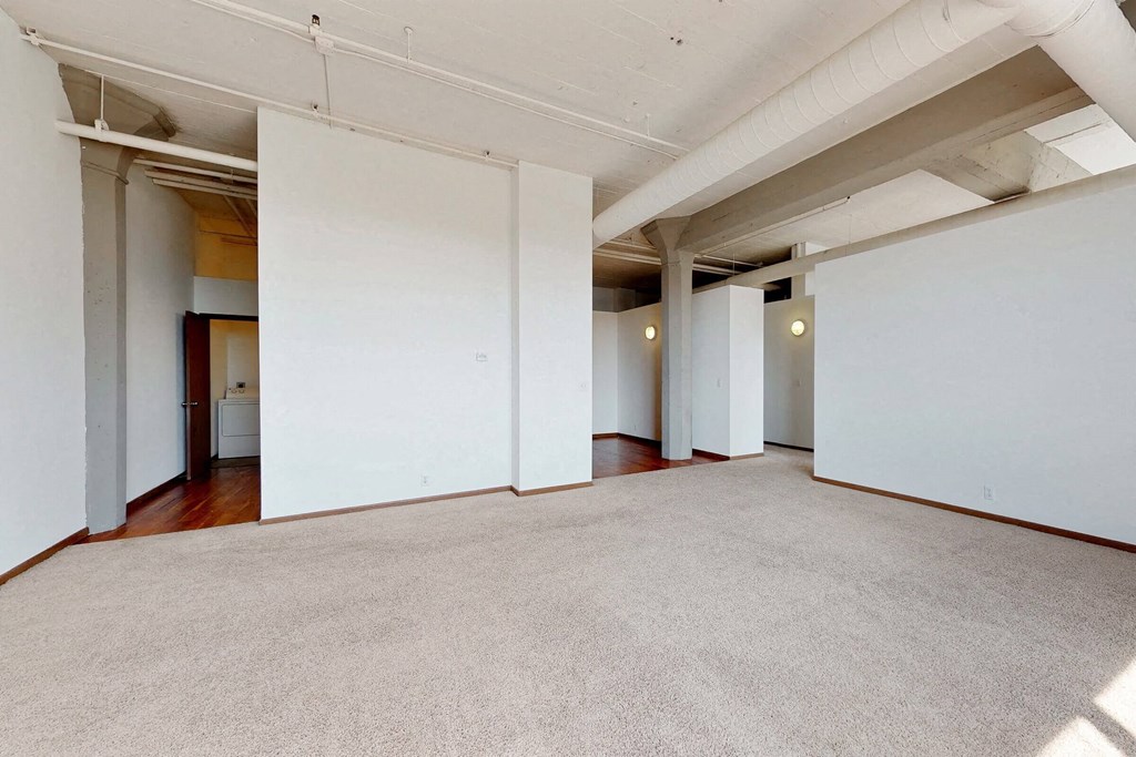 an empty room with white walls and a concrete floor