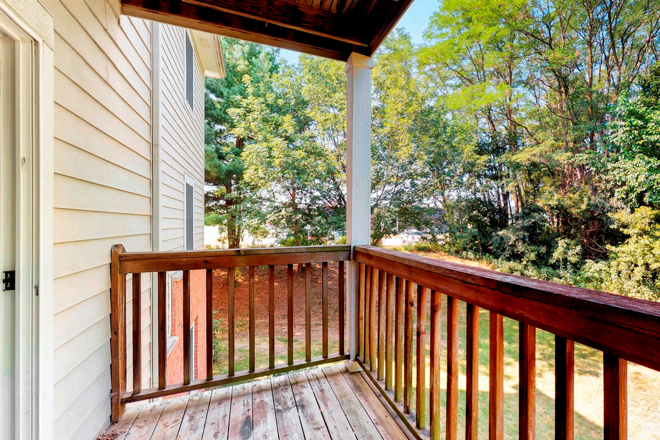the view from the deck of a cabin with trees