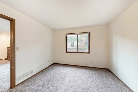 a living room with carpet and a window
