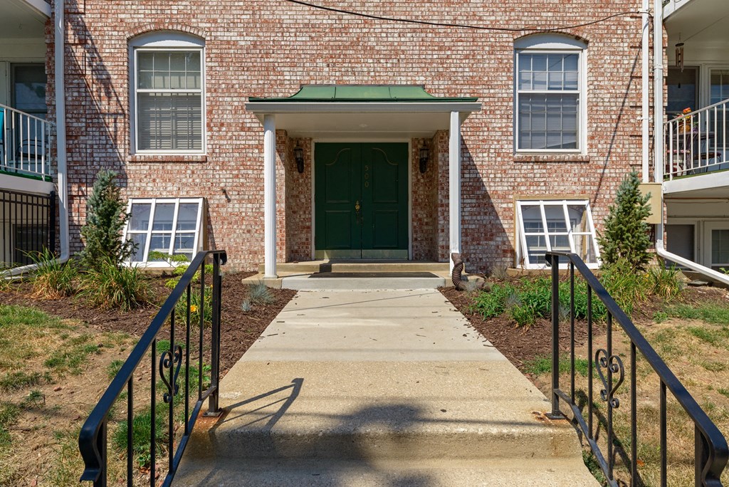 the entrance to a brick building with a green door