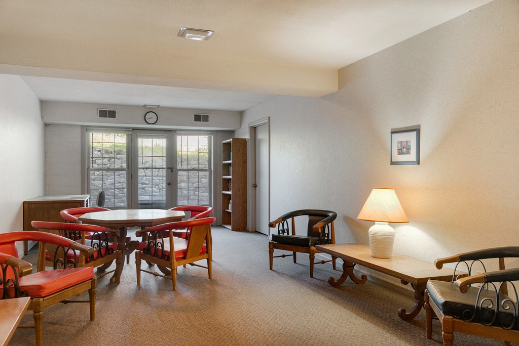 a living room with a dining room table and chairs