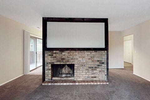 a living room with a fireplace and a tv on top of it