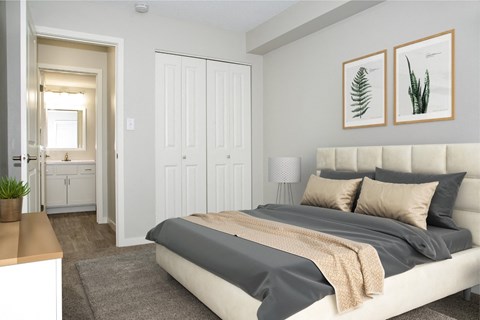 A bedroom with a large bed and two framed pictures on the wall.