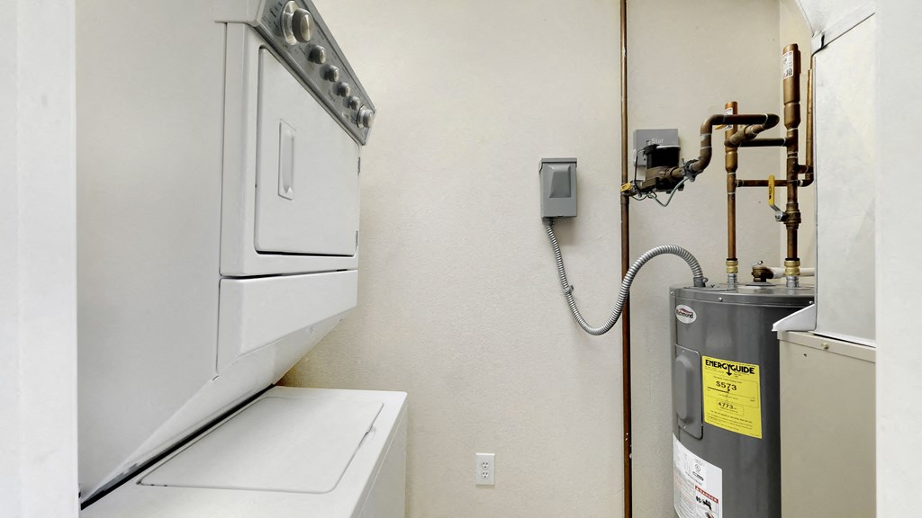 a kitchen with a stove and a refrigerator     and a water heater
