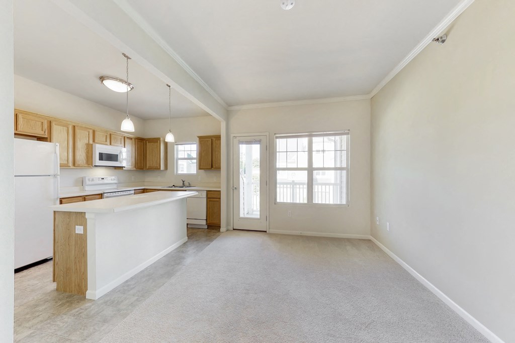 an empty kitchen with an island in the middle of it