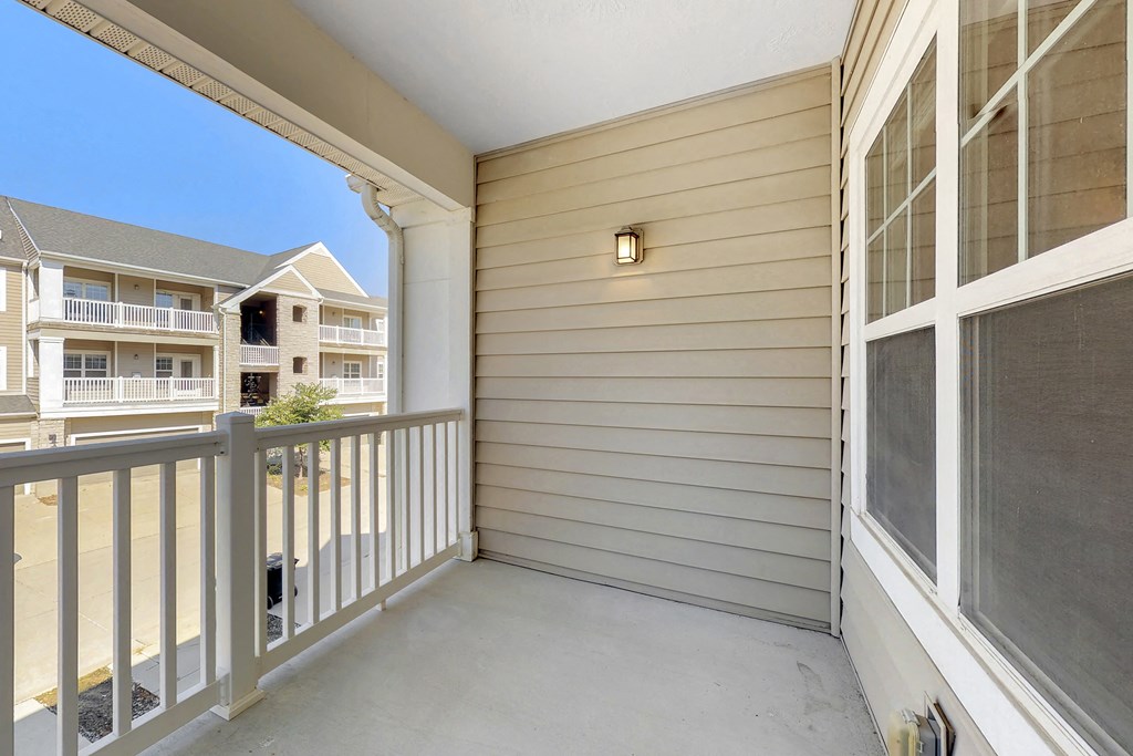 the spacious balcony has views of the street and the apartment buildings