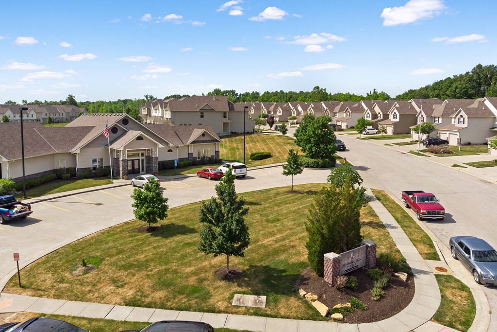 an aerial view of a neighborhood with cars parked in front of houses