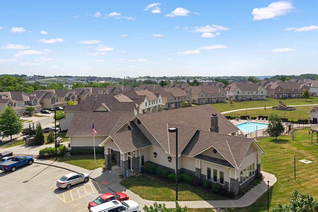 an aerial view of a large neighborhood of houses with a swimming pool