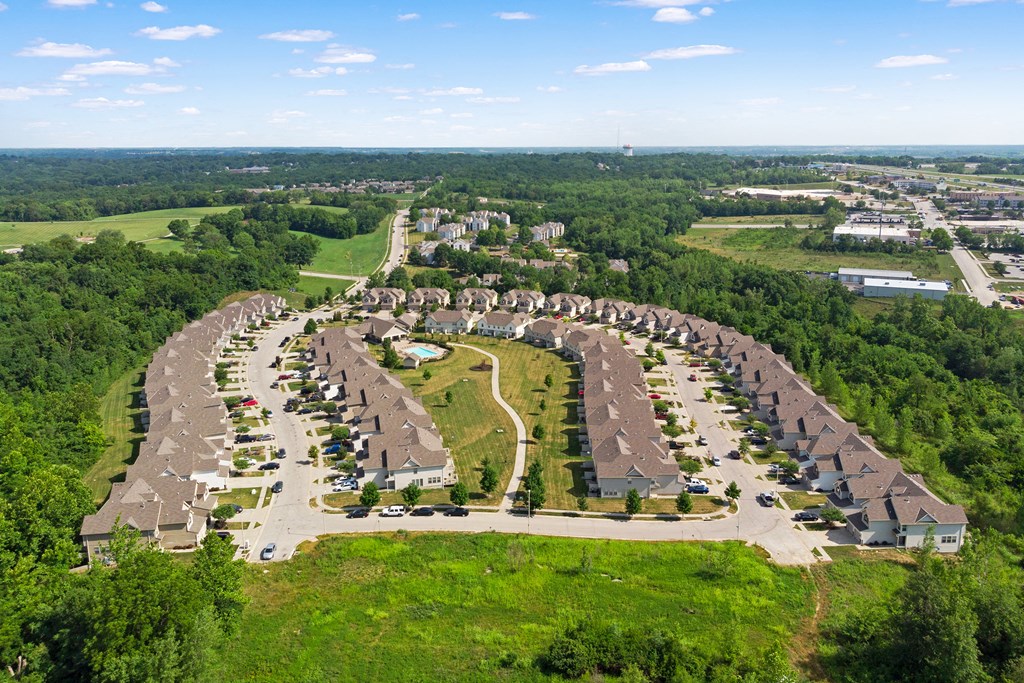 an aerial view of a parking lot with rows of houses