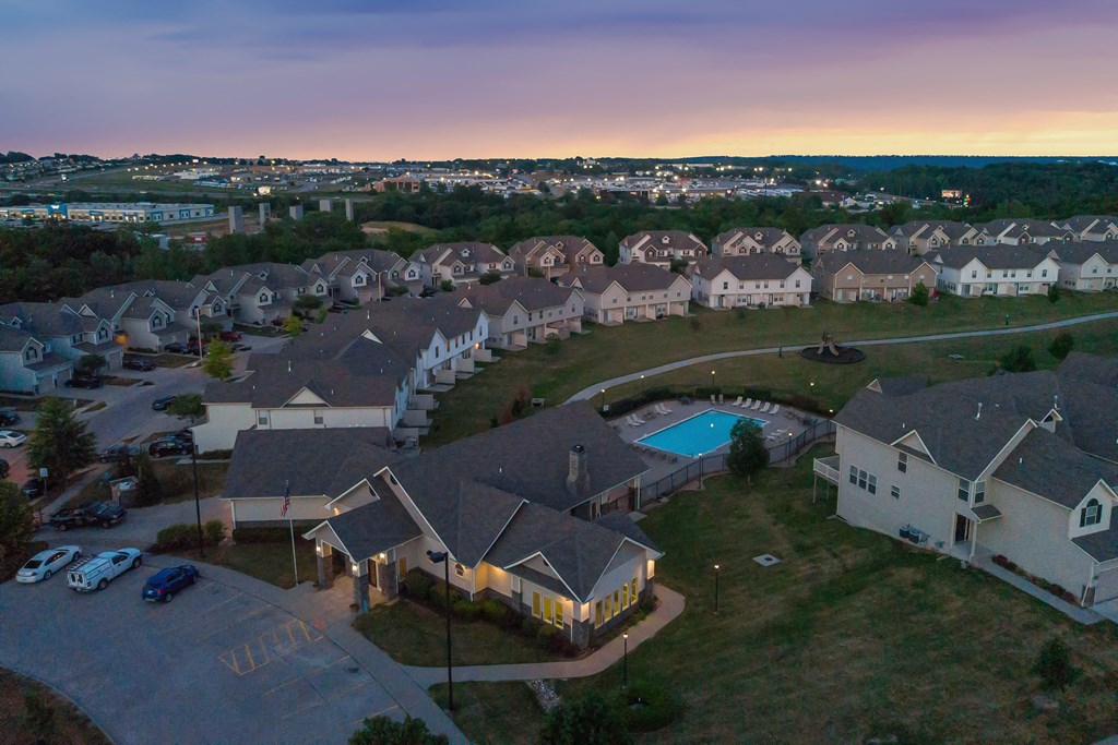 an aerial view of a neighborhood with houses and a swimming pool