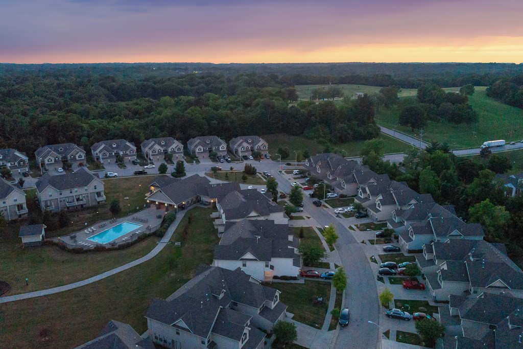 arial view of houses in a neighborhood at sunset