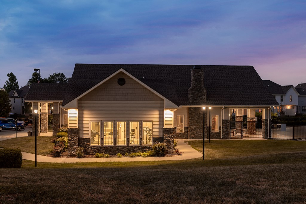 a home at night with lights on in the front yard