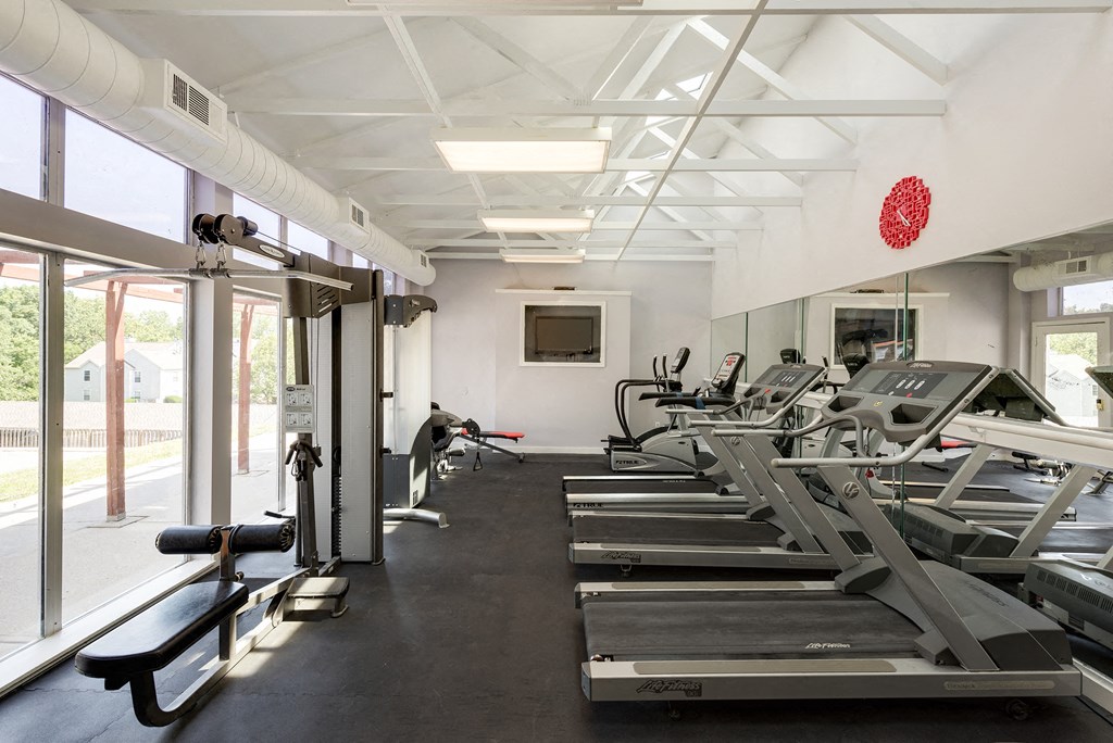 a gym with treadmills and other exercise equipment