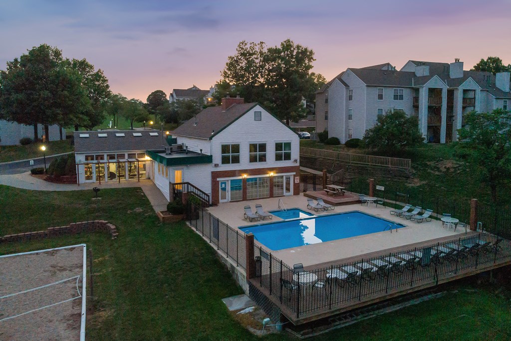a backyard with a pool and a house