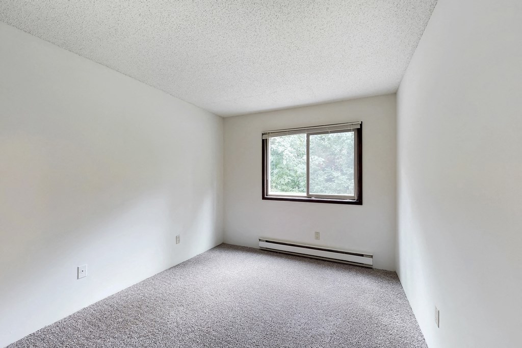 the living room of an empty house with a window