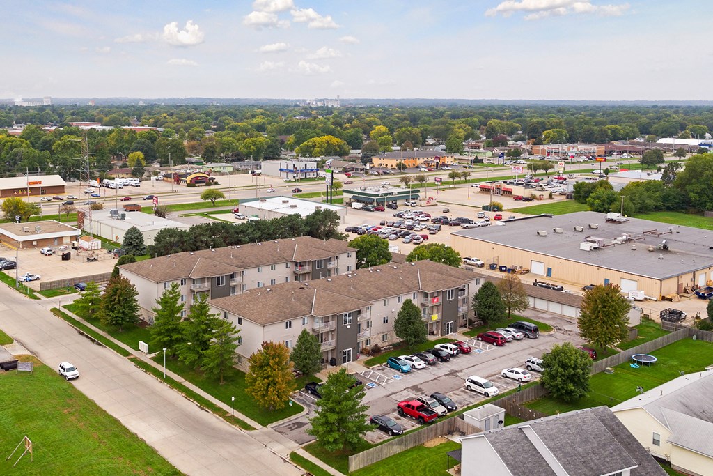 an aerial view of a city with buildings and a parking lot
