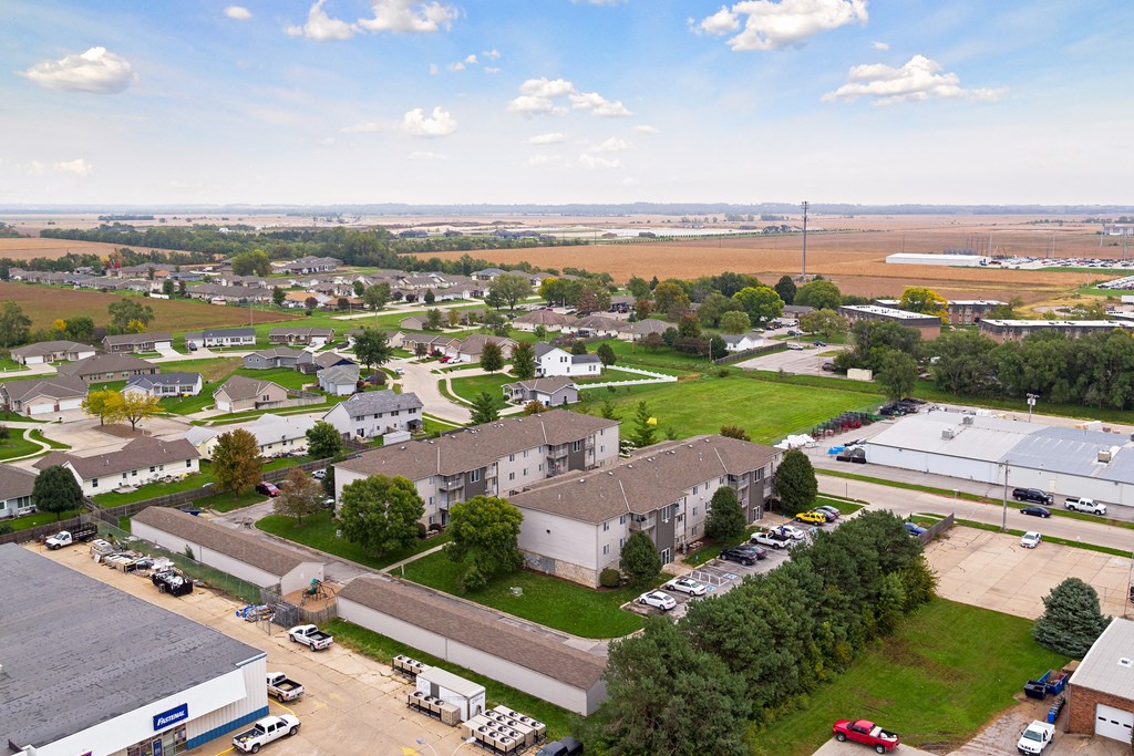 an aerial view of a neighborhood with houses and buildings and a parking lot