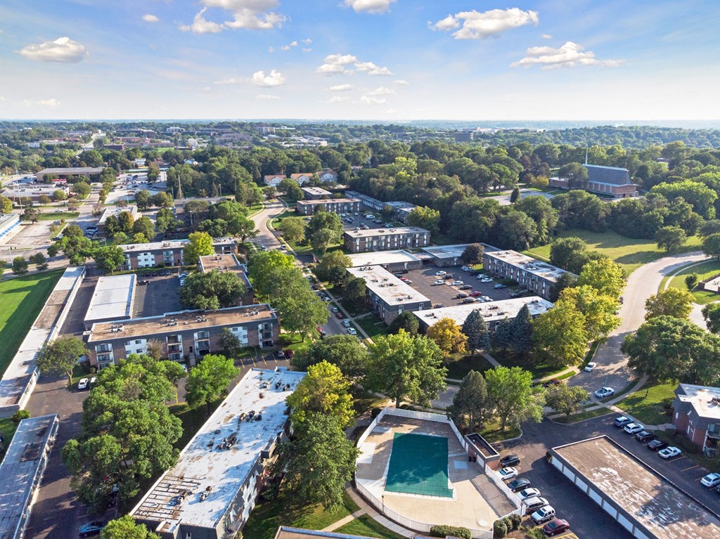 an aerial view of a city with buildings and trees