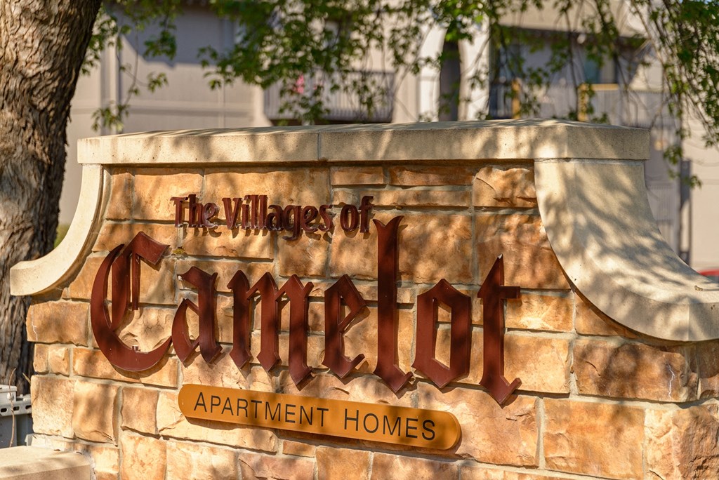 a sign for the village of cimarron apartment homes