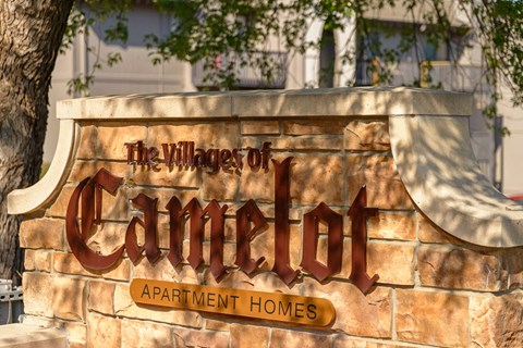 a sign for the village of cimarron apartment homes