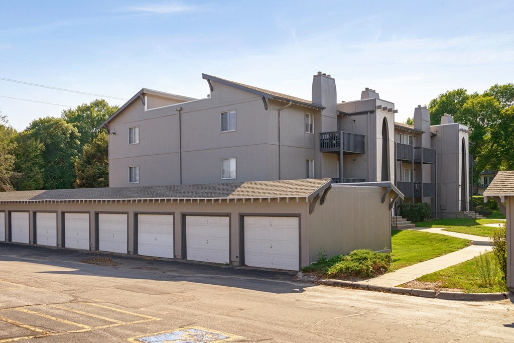 a large building with a garage with white doors