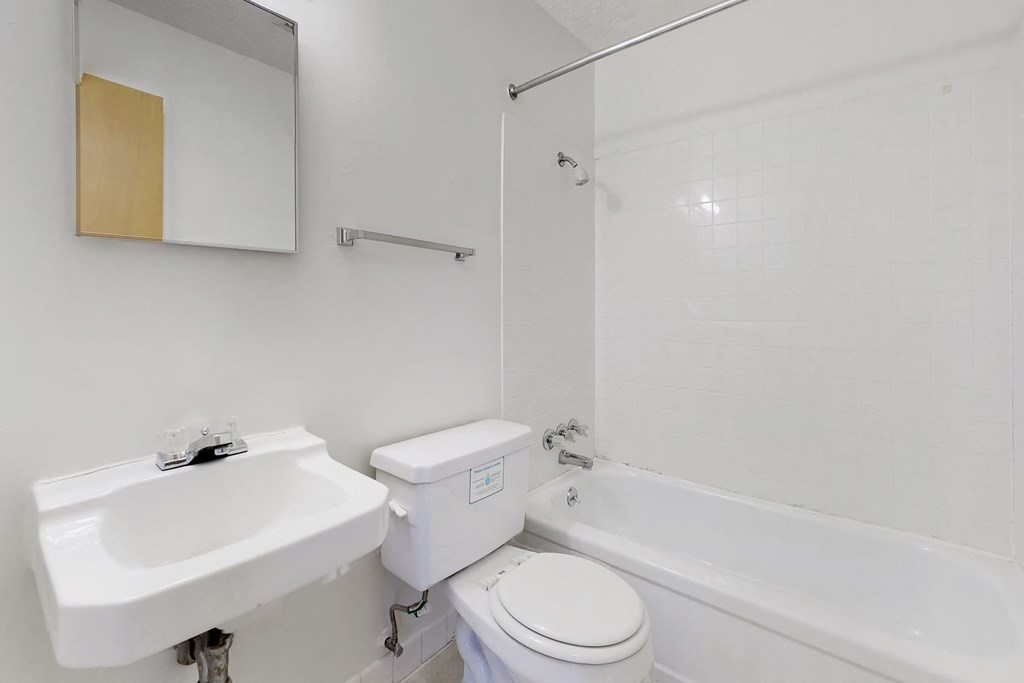 a bathroom with a sink toilet and a tub