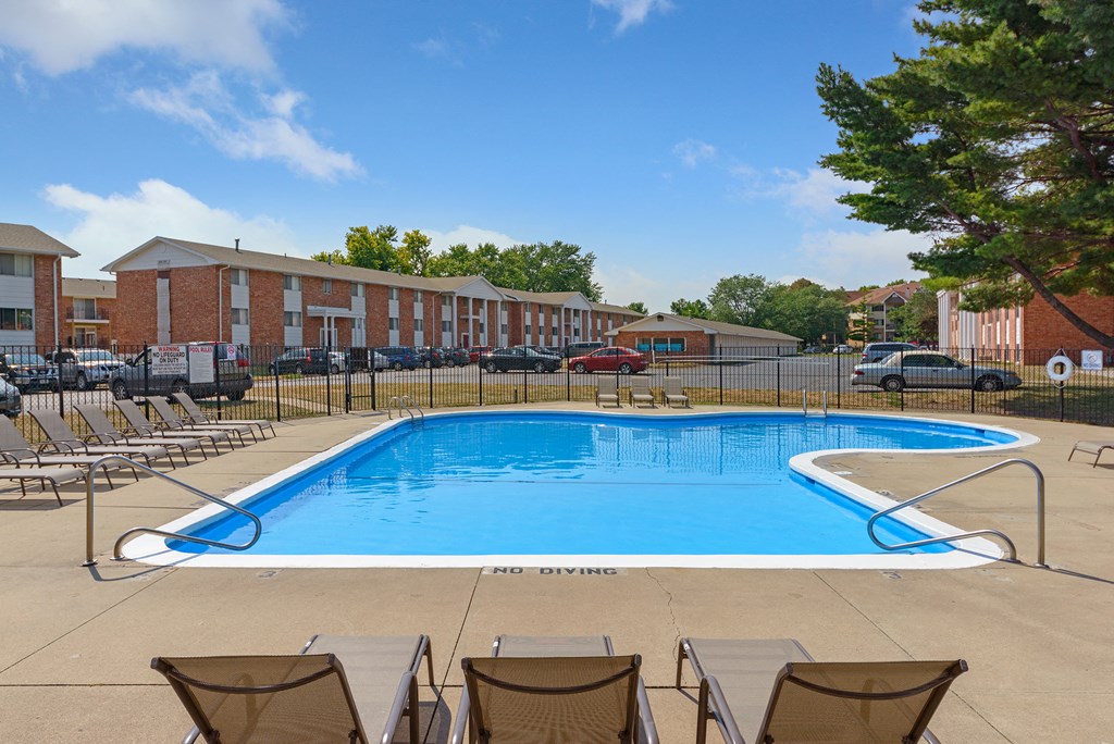 our apartments offer a swimming pool with chairs around it