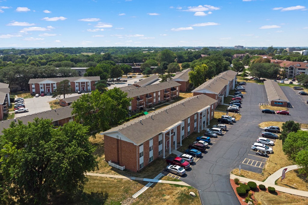an aerial view of a building with a parking lot