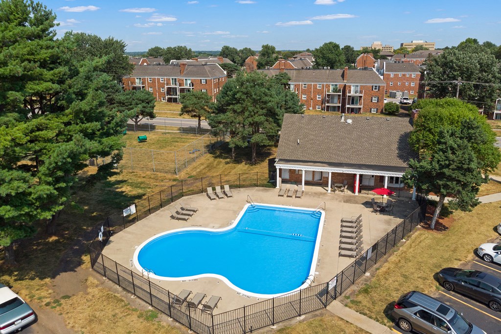 an aerial view of a swimming pool in front of a house