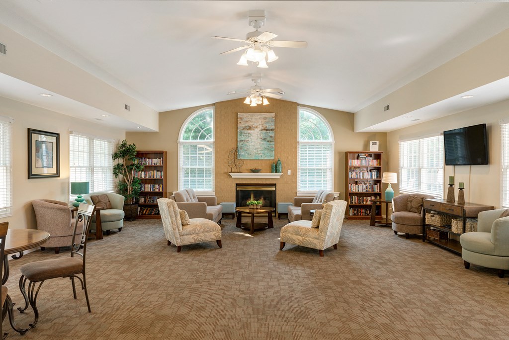 a living room with couches and chairs and a fireplace